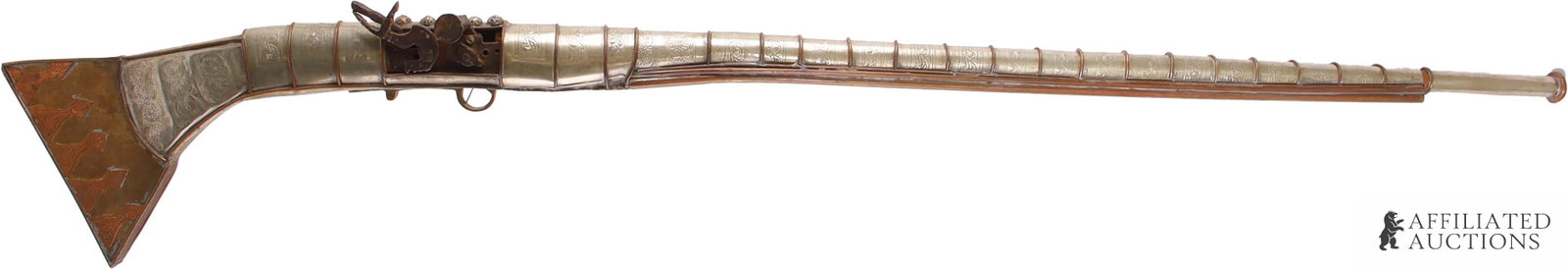 Ornate Stamped Metal Balkan Jezail Miquelet Musket: Antique jezail musket, probably Balkan, Ottoman Empire, ca. 18th century. Has been almost totally enclosed in an ornate metal sarcophagus of brass, copper and tin or possibly silver alloy. Only the
