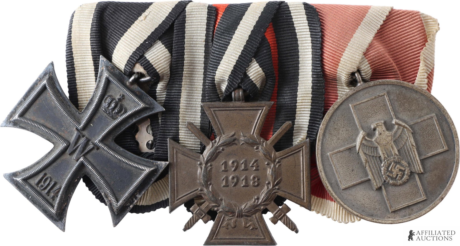 Three-Place Medal Bar WWI & WWII Red Cross: Original three-place medal bar. Includes 1914 Iron Cross, 2nd Class, Hindenburg Cross (Reverse marked "W.K.") and Third Reich DRK Red Cross Medal for Social Welfare. Reverse of medal bar marked "Tz" i