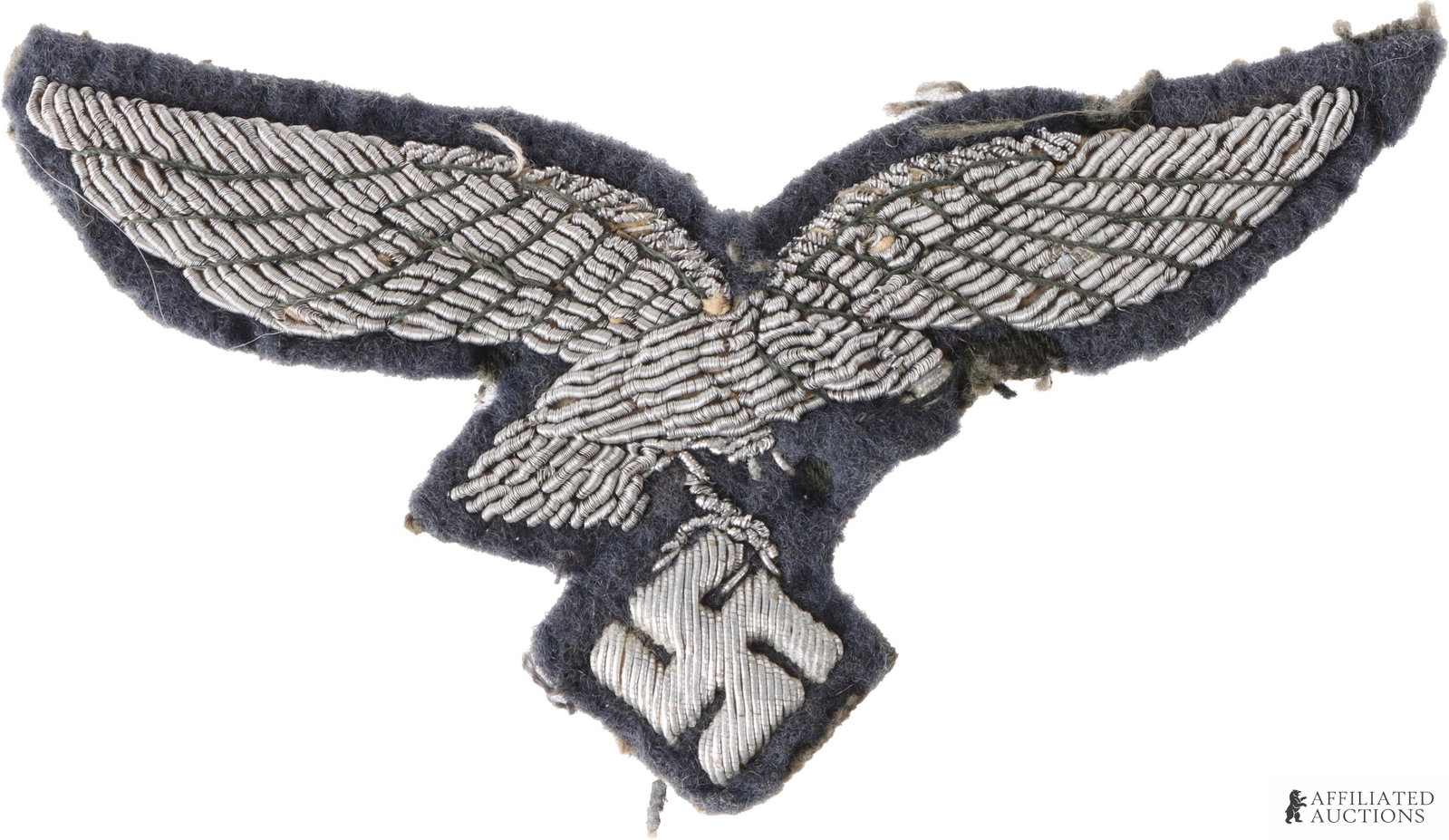 Luftwaffe Breast Eagle Patch WWII German Reich: A Luftwaffe breast eagle patch, featuring wire embroidery on a blue-gray fabric. Construction is aluminum bullion on wool or felt. Non-fluorescing, but unauthenticated.
