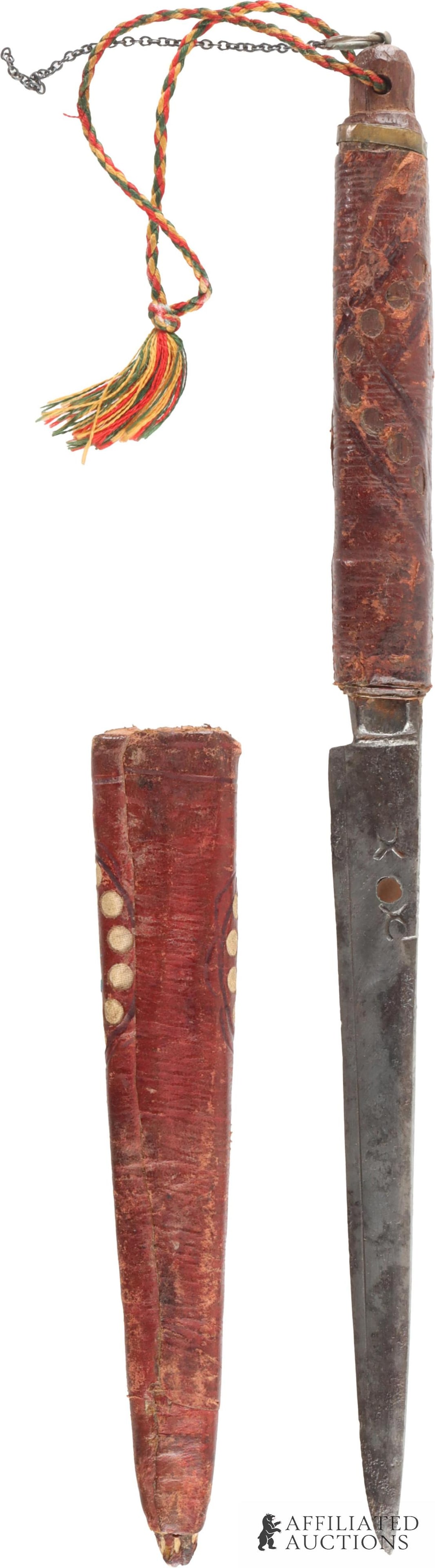 Bou Saadi Algerian Khodmi Dagger with Scabbard: Antique Bou Saadi Algerian khodmi dagger with leather scabbard. Single-edged steel blade with grooved spine and copper inset. Lanyard pommel. A fascinating, quite sturdy knife. Overall length 11.75 in