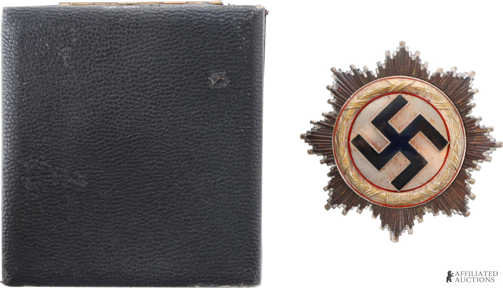 WWII German Cross in Gold 16 Rivet Type: WWII German Cross in gold. Rarer 16 rivet type. Features black enameled swastika on starburst pattern. Case measures 83mm x 76mm. Medal measures 63mm. | This lot has a reserve.