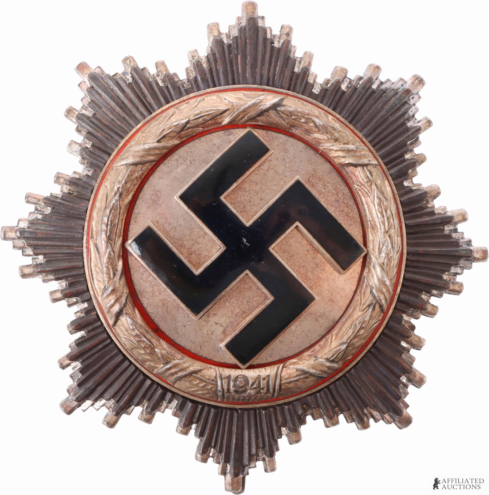 WWII German Cross in Silver 6 Rivet Type: WWII German Cross in Silver. Six rivet type. Features black enameled swastika on starburst pattern. Labeled 1941. Diameter 62.5mm. | This lot has a reserve.