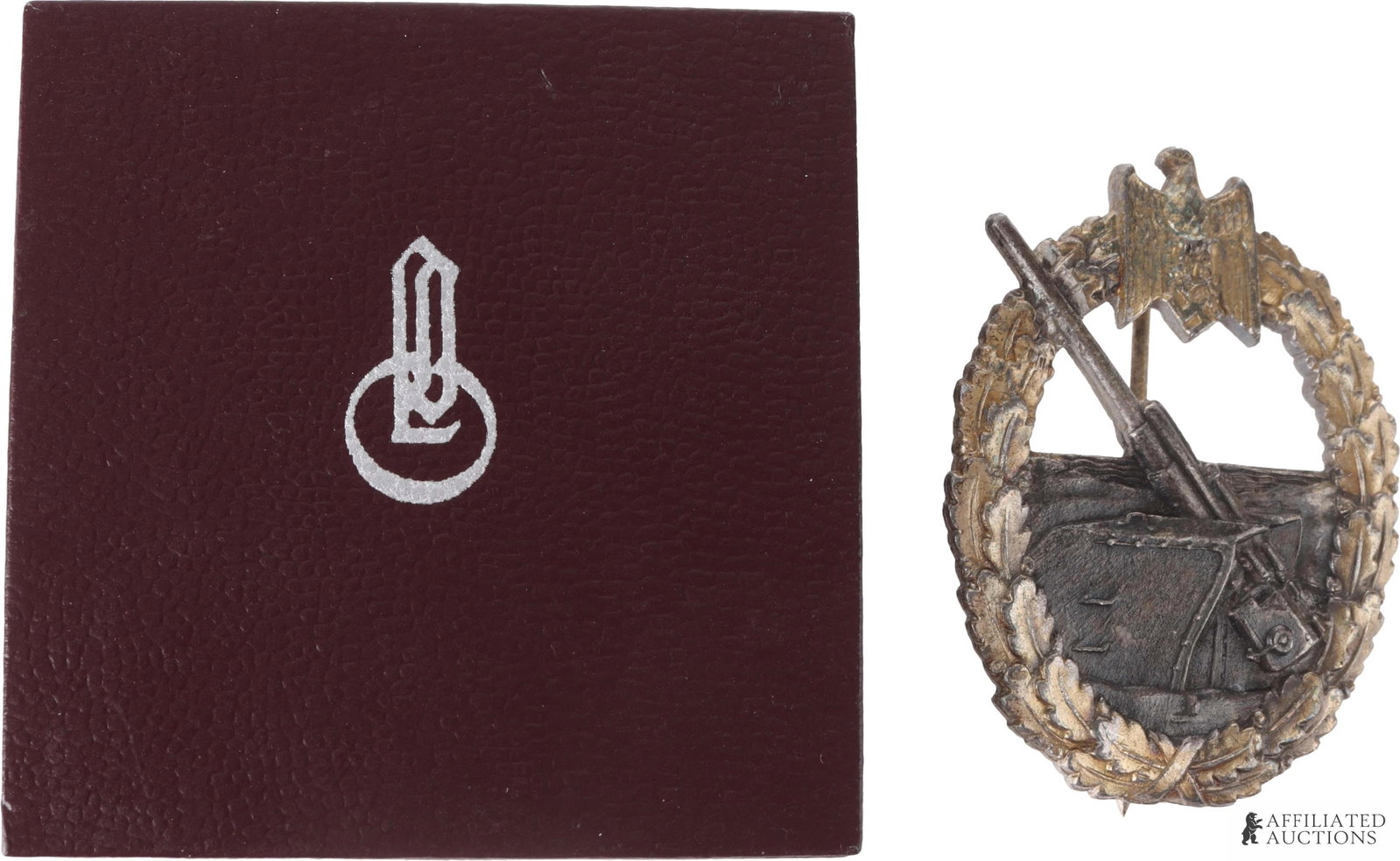 Kriegsmarine Coastal Artillery Badge Wiedmann: Cased WWII German Kriegsmarine Coastal Artillery Badge. Solid-struck. Reverse has maker's mark of E. Ferdinand Wiedmann, vertical thin wire pin and crimped sheet metal catch. Height 53.65mm. Width 41.