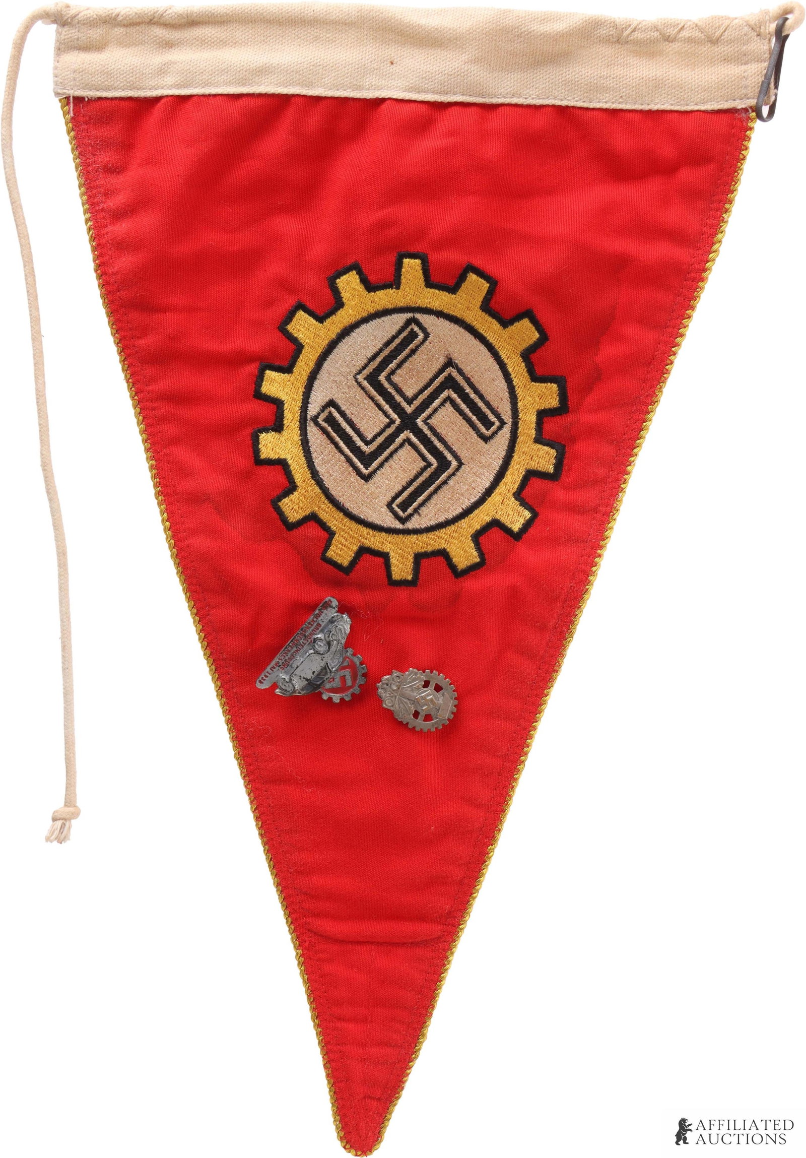 WWII German DAF and Volkswagen Pins: WWII German DAF German Labour Front factory honor pennant with gold cogged wheel. Has a Volkswagen factory pin and a labor organization badge attached. Pennant measures 9in x 14in. | This lot has a re