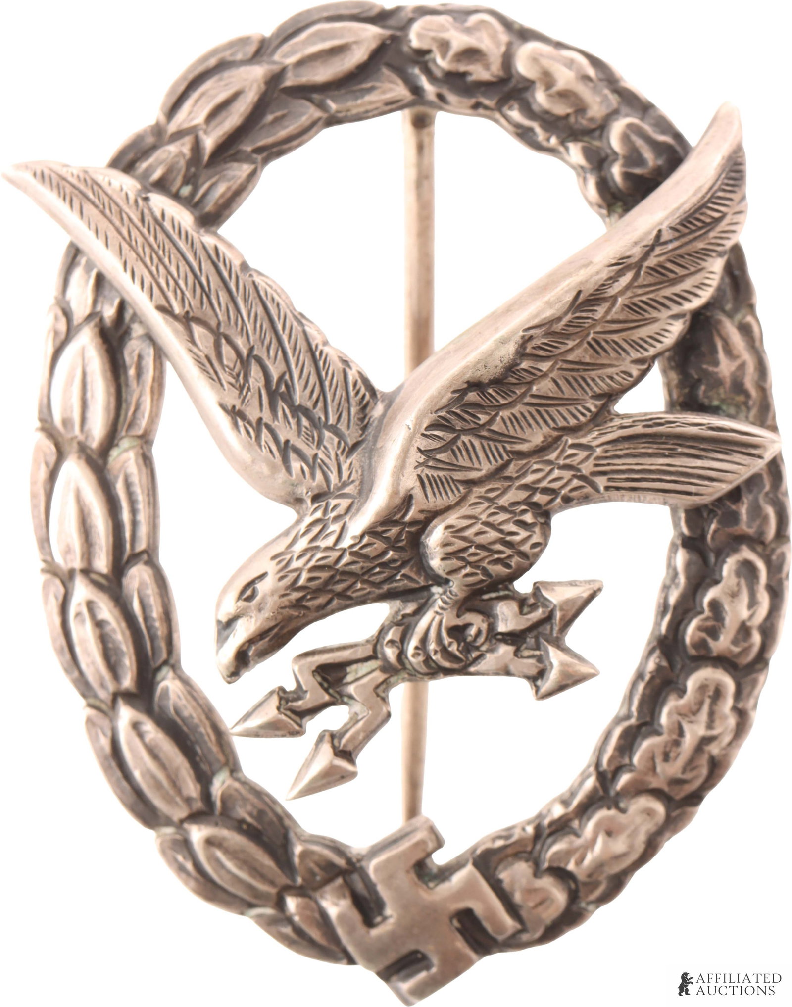WWII German Luftwaffe Radio Operator Badge: WWII Luftwaffe Radio Badge Operator Badge. Diving Eagle clutching lightning bolt, riveted to oak and laurel wreathe. reverse marked with Imperial German silver mark and 800 for purity. 39mm by 52mm. P