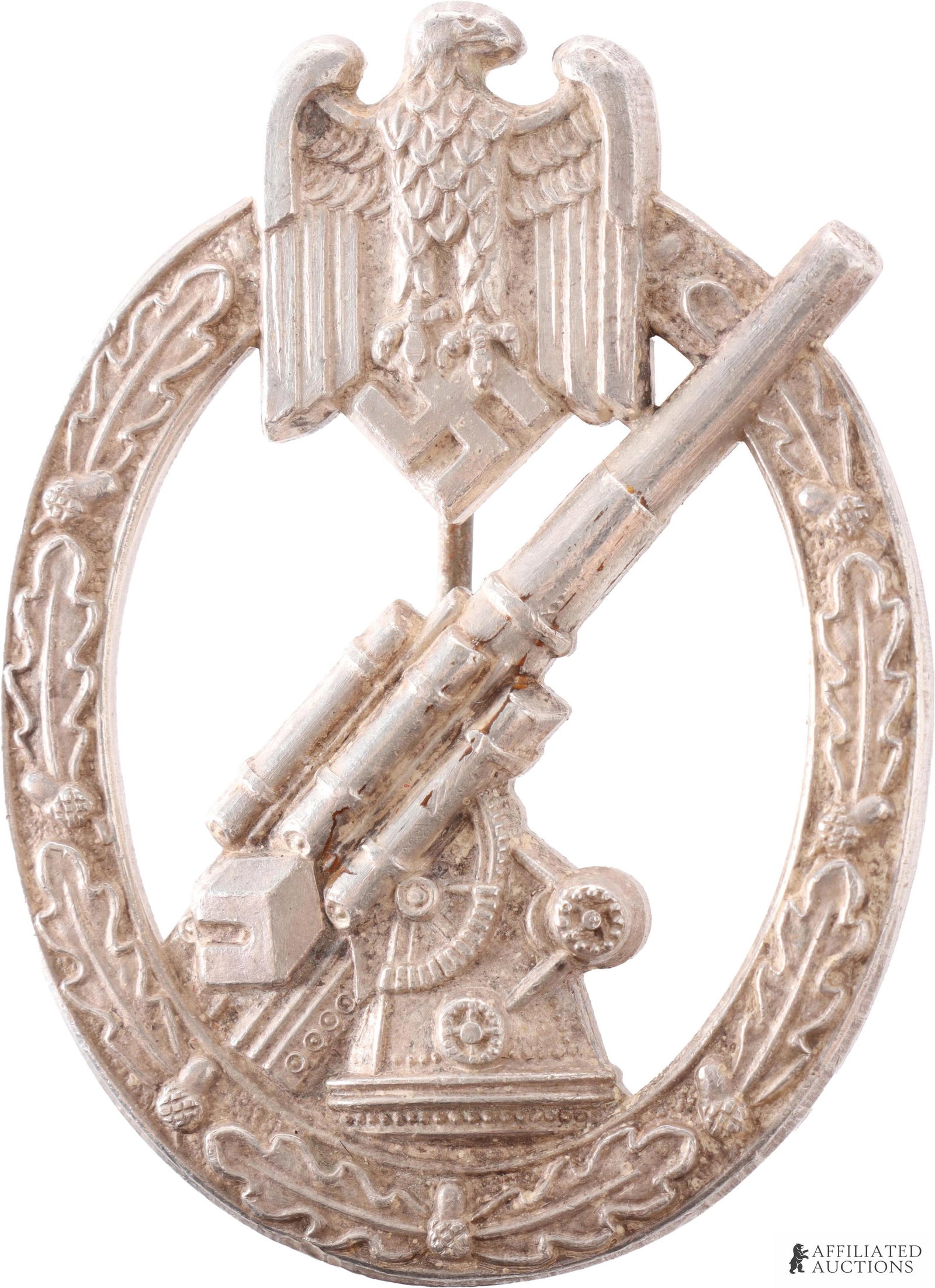 Heer Anti-Aircraft Flak Badge in Silver WWII: Heer Anti-Aircraft Badge in silver. Unmarked. Solid-struck. Reverse has thin wire pin with round wire catch. Height 60mm. Width 45mm. Gross weight 38.5 grams.