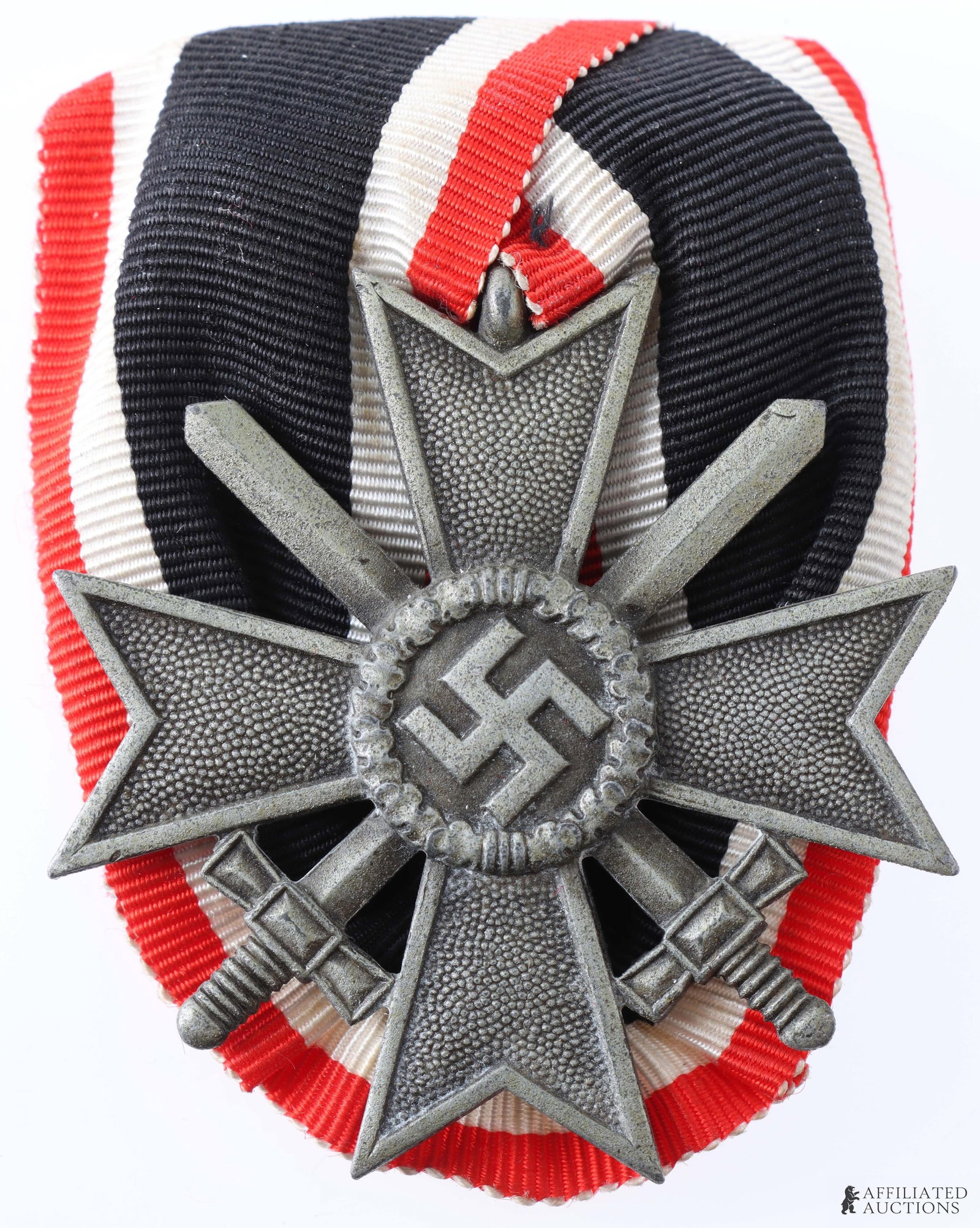 War Merit Cross with Swords 2nd Cl. Court Mounted: WWII German War Merit Cross with Swords, 2nd Class, court-mounted on ribbon with red wool backing and horizontal wire pin. Zinc alloy construction. Dimensions 48x48mm.