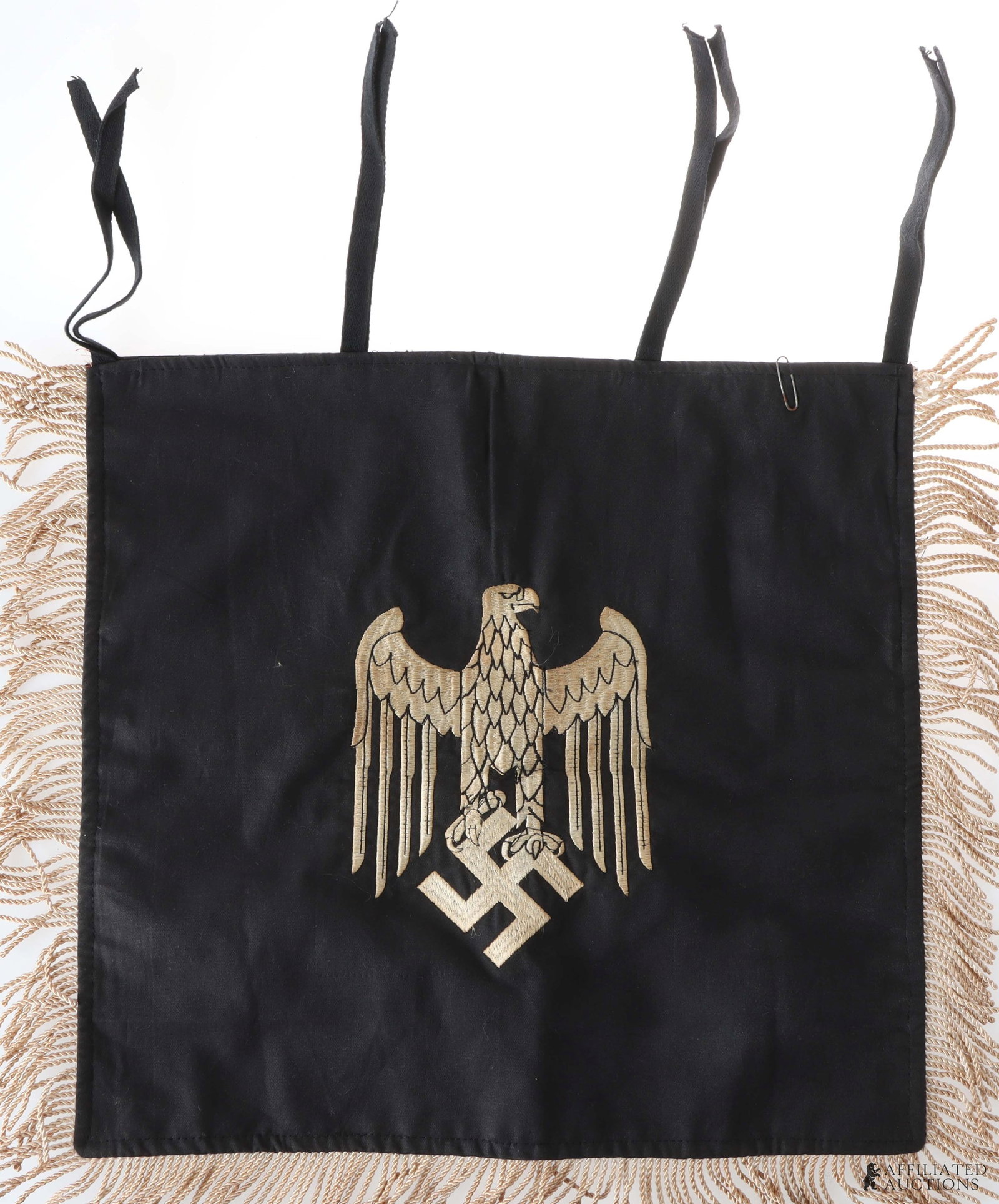 Army Heer Trumpet Banner WWII German: Double sided, cloth construction. Large Wehrmacht eagle with silver fringe on three sides. Complete with three sets of ties for the instrument. Measures 15in x 17 in. | This lot has a reserve.