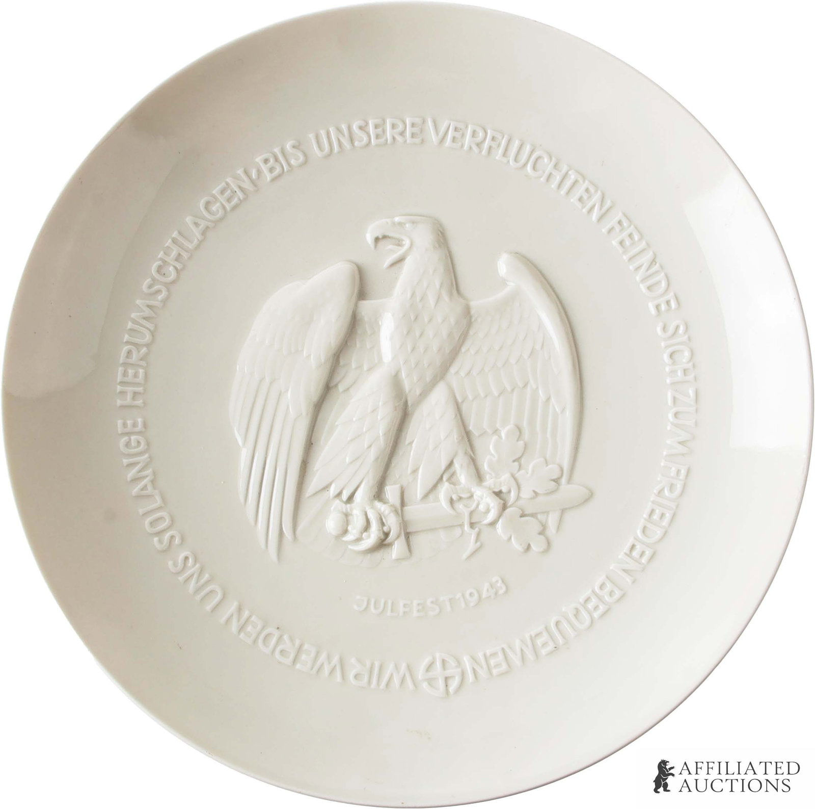 SS Allach Porcelain 1943 Julfest Eagle Plate: SS Allach 1943 Julfest plate. Image in raised relief of eagle perched on sword with oak leaves. Reverse marked "Worte Friedrichs Des Grossen Aus Einem Briefe An d'Argens | Im Jahre 1758." Diameter 9.7