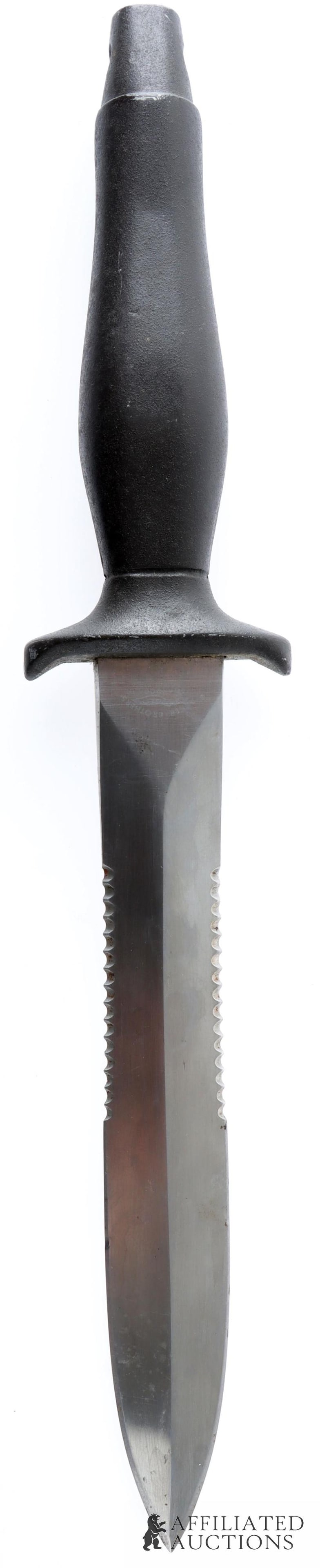 Parker Brothers Version of Gerber Fighting Knife: A Parker Brothers version of the Gerber fighting knife from the Vietnam War. Cat tongue handle, partially serrated blade. Made in Japan from surgical steel. Entire item is approximately 12 inches.