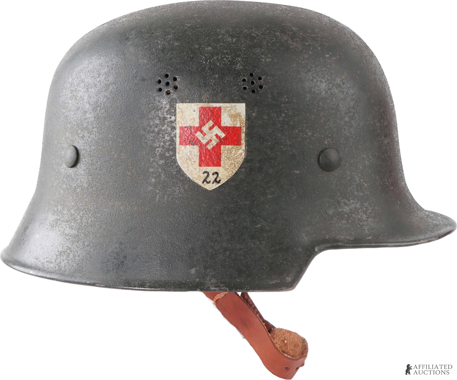 WWII German M34 Double Decal Red Cross Helmet: M34 double decal red steel combat helmet. Exterior has textured field gray paint. Interior has eight-tongue leather with Y-strap chinstrap configuration. Skirt marked in paint "Feldlazarett St. Afra N
