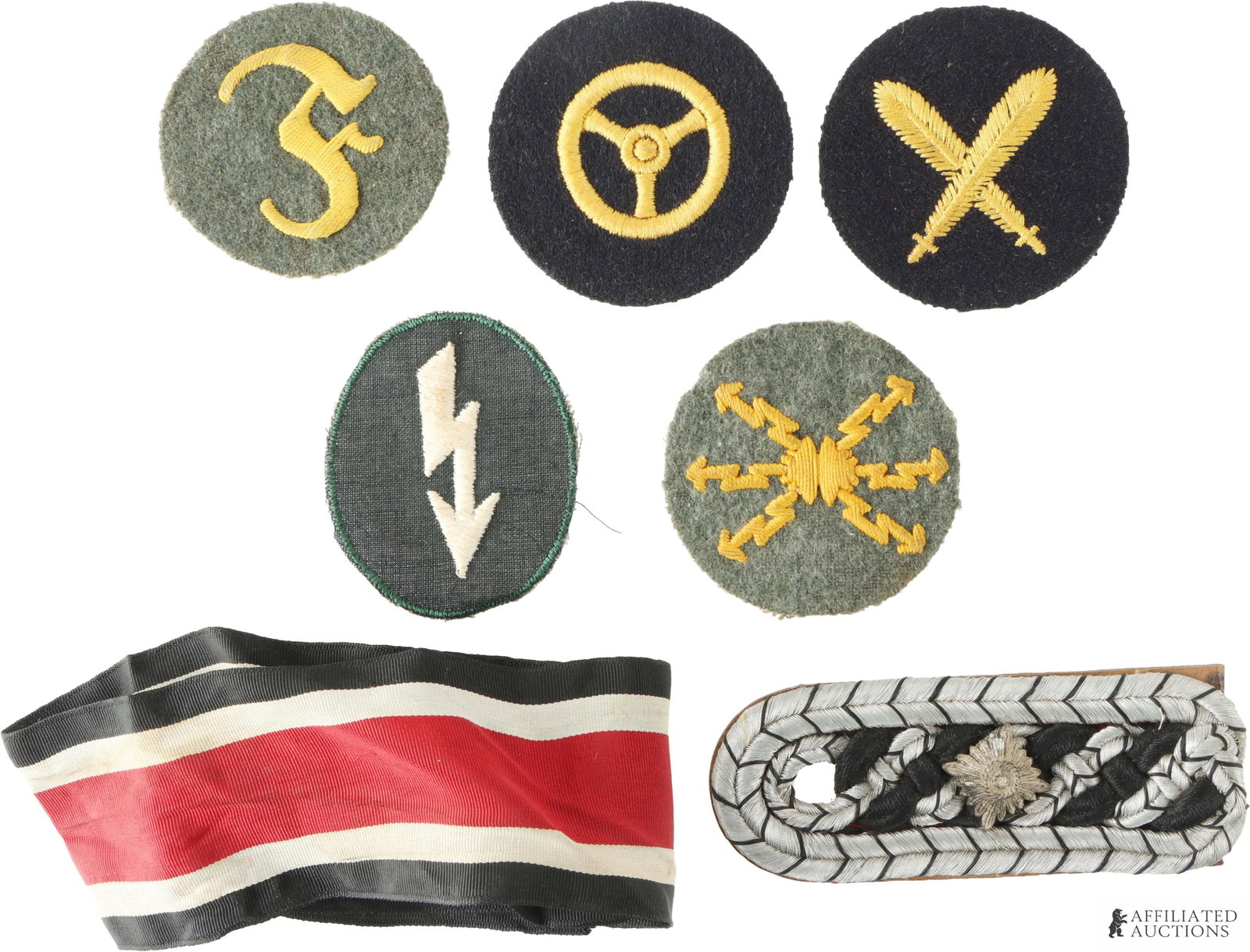 WWII German Insignia Patches Knight's Cross Ribbon: Lot of seven (7) pieces. Includes metallic wire shoulder board with single pip on cardboard backing, Knight's Cross of the Iron Cross ribbon, and five circular insignia patches.