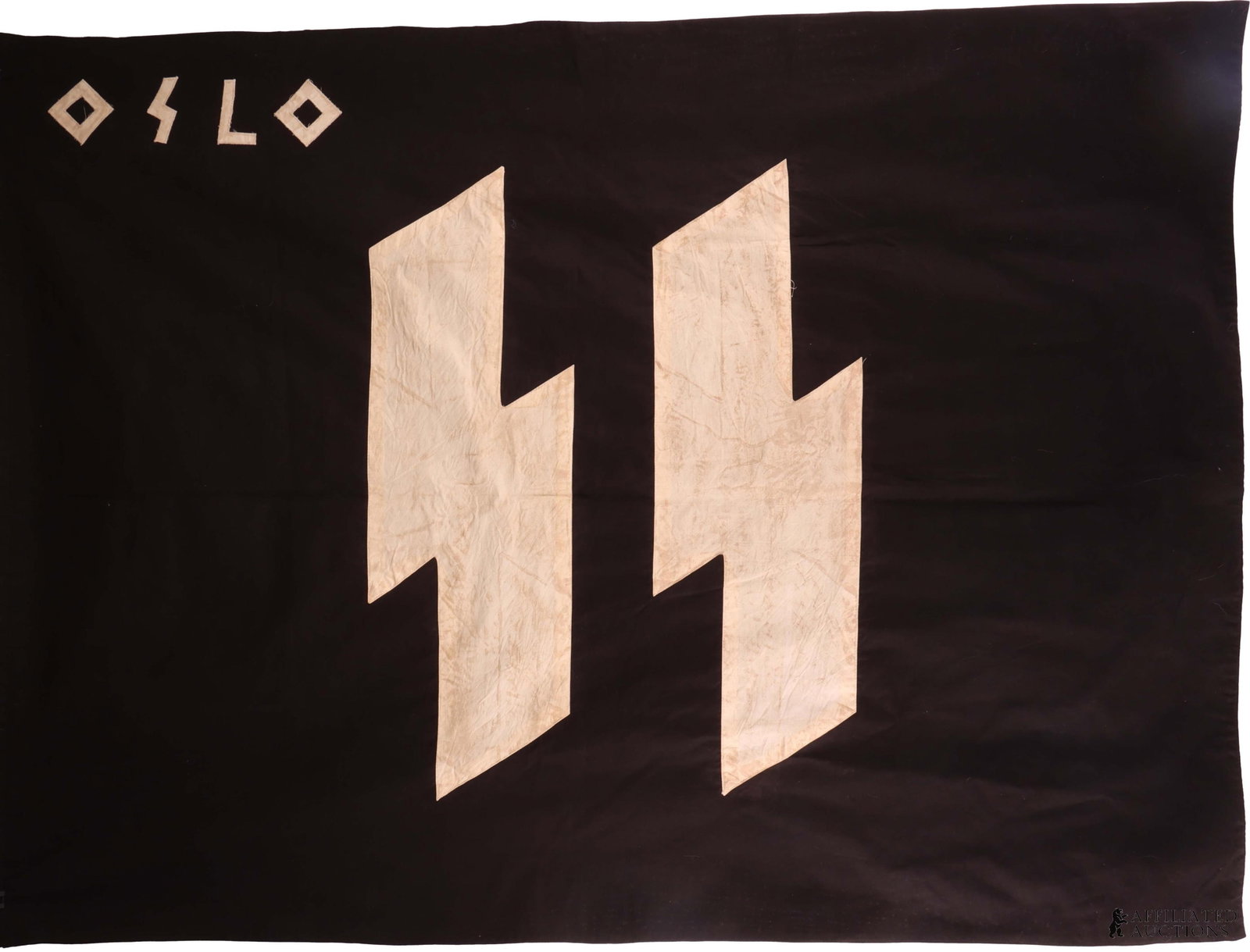 WWII German SS Norway Occupation Flag: Double sided cotton cloth construction. Both sides with dual cut-out white cotton runes, machine-applied at center. It measures 50 X 37 inches. Non-fluorescing.