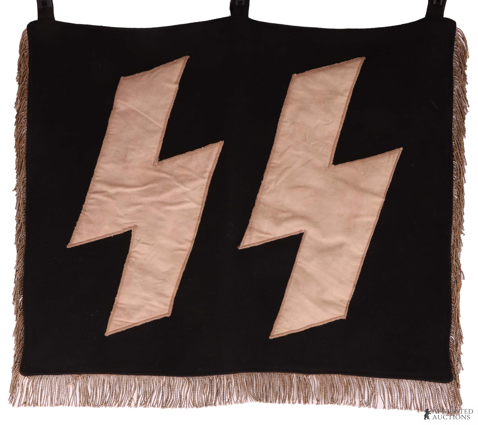 WWII German SS Trumpet Banner: Heavy doe skin wool construction. Double sided. Features cut out machine stitched SS runes with bullion fringe. It measures 22 X 18 inches. The fringe measures 1.5 inches long with a thickness of .95m
