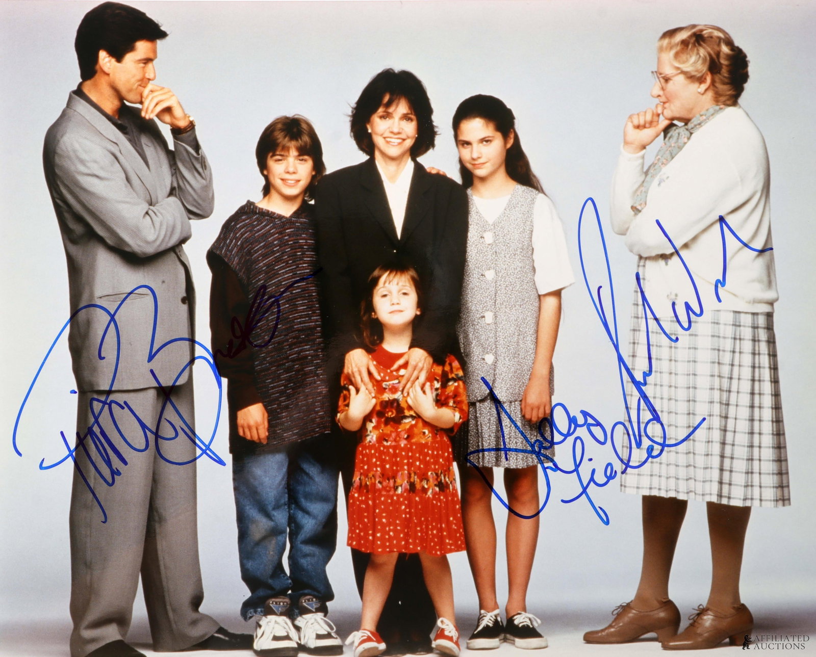 Mrs. Doubtfire Cast Signed Photo Williams Brosnan: A signed photo of the cast from Mrs. Doubtfire. Signatures include Robin Williams, Pierce Brosnan, and Sally Field. This autograph was collected for James Reeves, who used a staff of agents to acquire