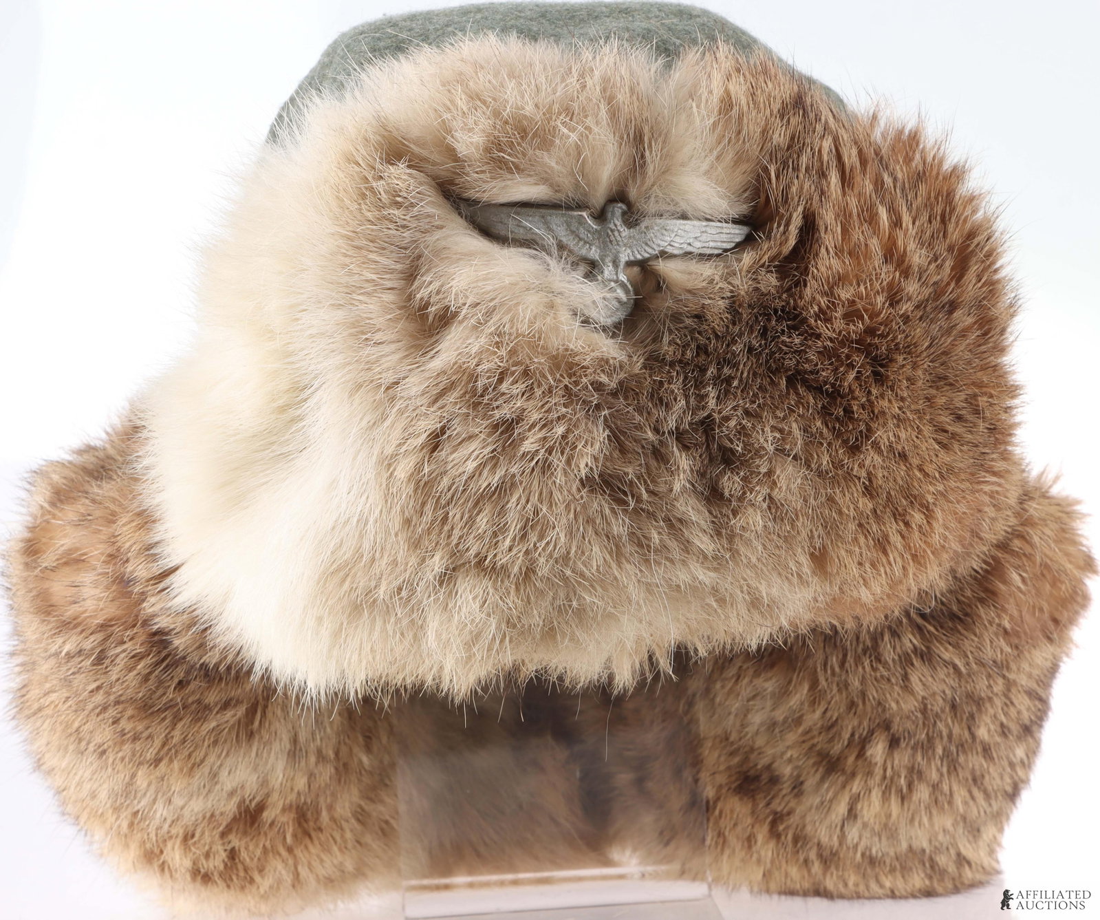 WWII German Wehrmacht Winter Fur Hat: An original WWII German army winter fur hat (pelzmutze). Introduced in 1942 for troops serving on the eastern front. The hat is constructed with a field-gray wool upper body and features natural brown