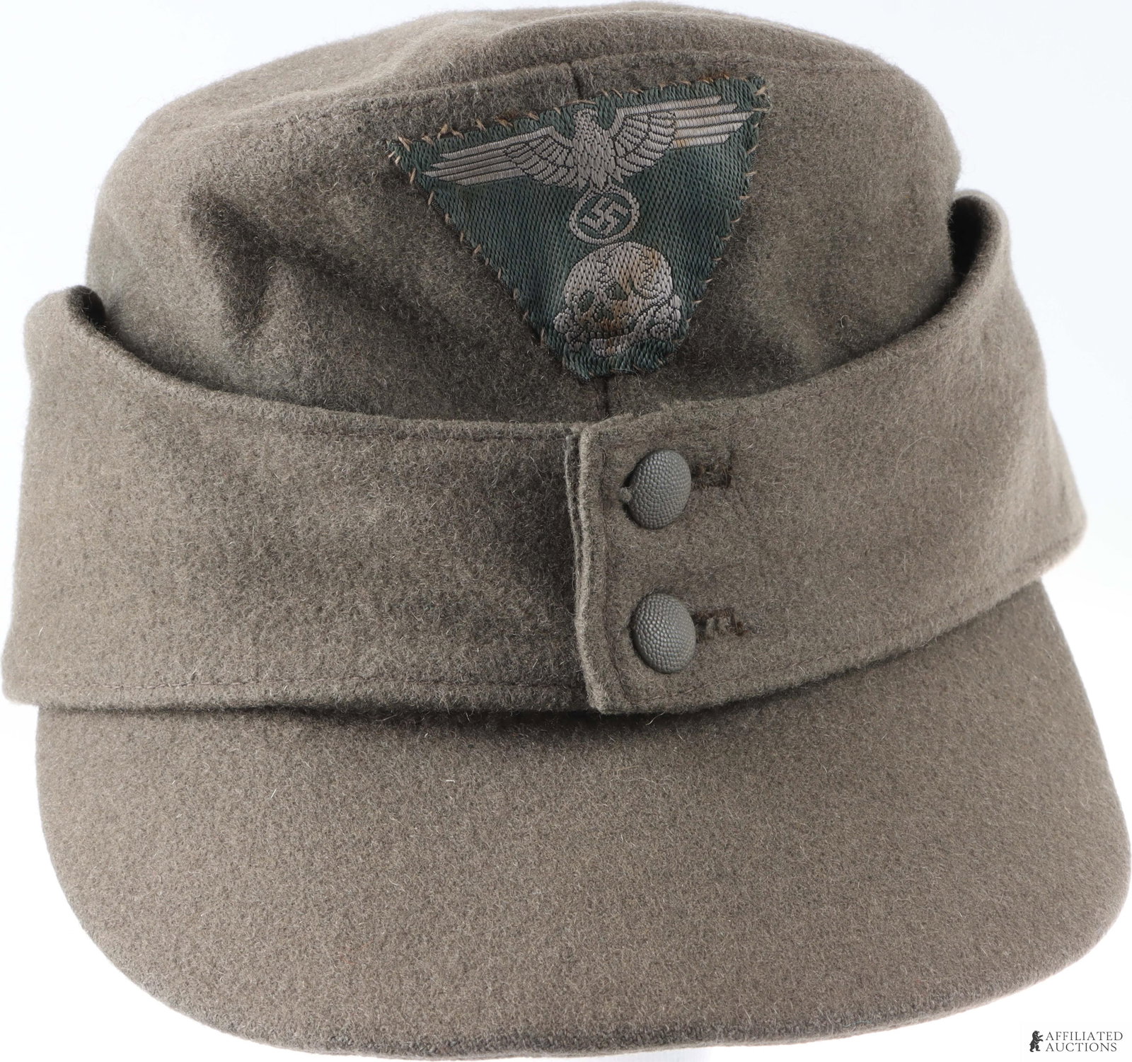 SS M43 Field Cap Size 59 WWII German: M43 field cap of grey wool with SS BeVo insignia and pebbled aluminum buttons marked "Extra Fein." Interior has tan cotton liner ink-stamped "59.".