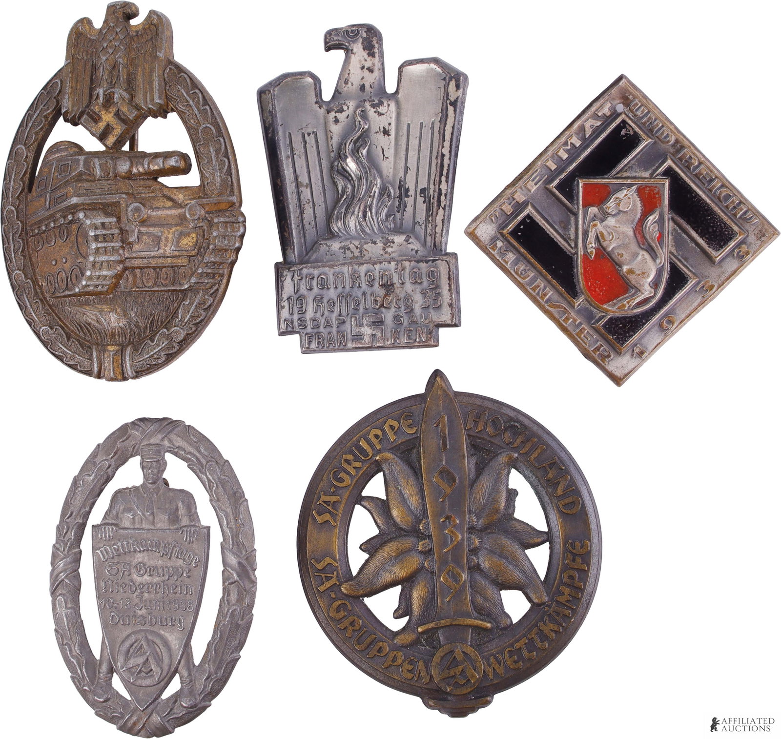 Lot of 5 WWII German Badges Political & Military: A lot of five unmarked WWII German badges. Includes the following: 1) a 1 3/4 inch by 2 1/2 inch Panzer Assault badge; 2) a 2 inch by 2 inch Munster 1933 tinnie; 3) a 2 1/8 inch by 1 3/8 inch Frankent