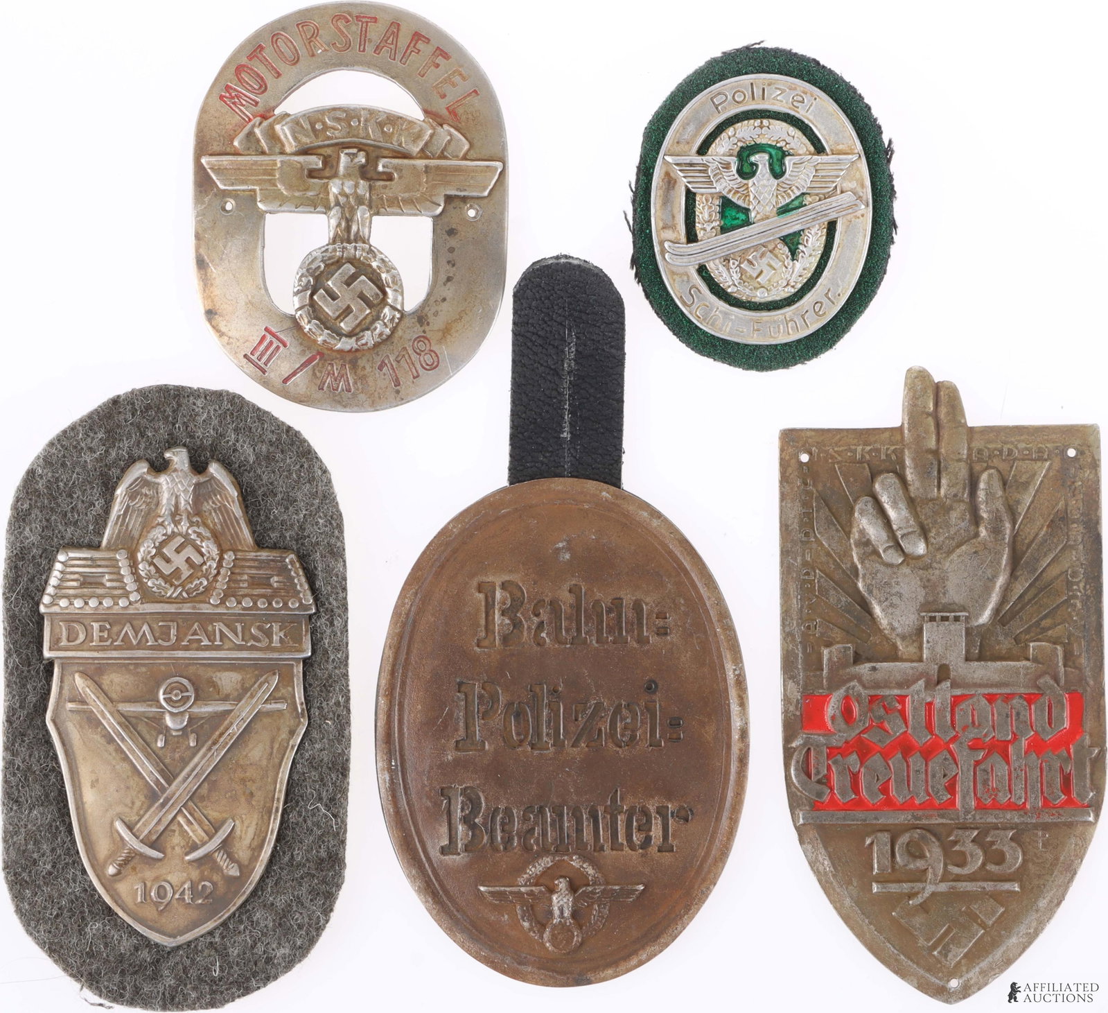 Vintage German Military Plaques/Badges Third Reich: A lot of five vintage German plaques and sleeve badges. Includes the following: 1) An Ostland Treuefahrt 1933 memorial plaque; 2) a German Railway Police Official badge; 3) a Police Ski leader tinnie 