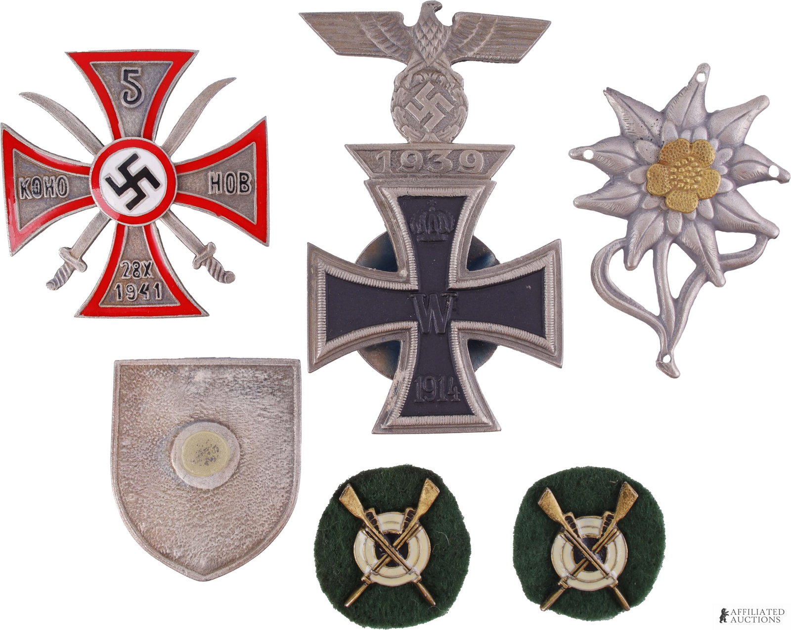 WWII Military Badge Pins & Insignia Lot of 4: A lot of four WWII military badges and insignia. Includes the following: 1) 1914 German Iron Cross 1st Class, mounted in a screwback 1939 German Iron Cross frame, measuring 1 3/4 inches by 2 7/8 inche