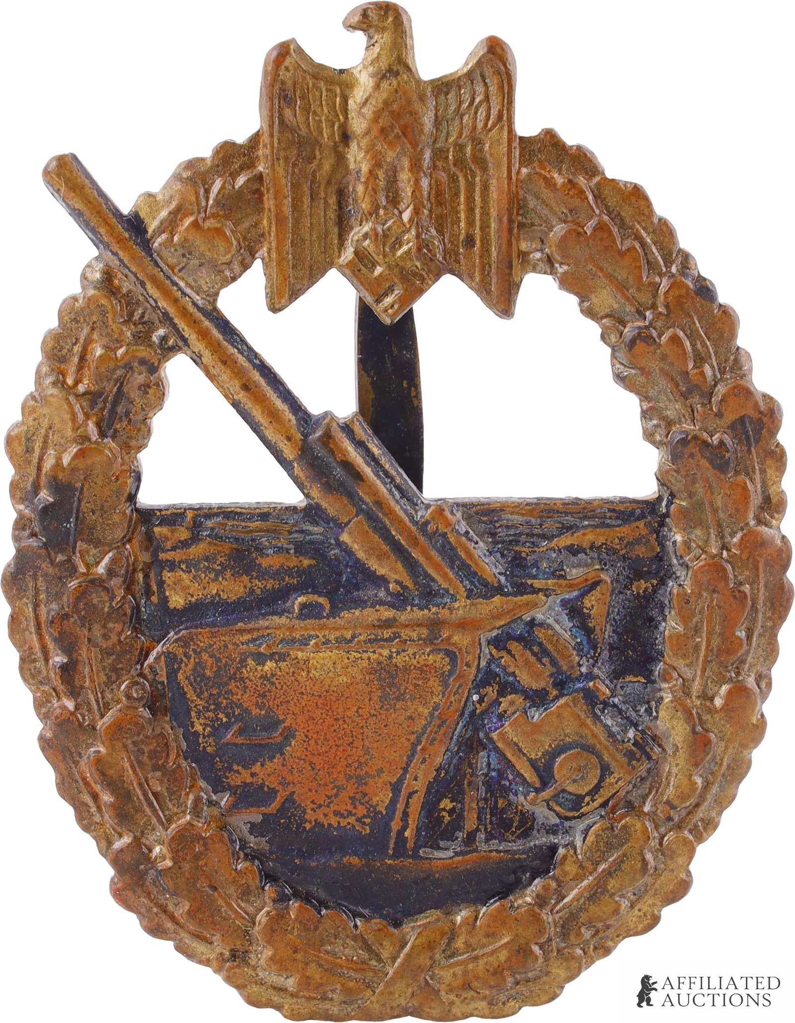 WWII German Army Coastal Artillery Badge: Tombak construction with brass gilt finish. Reverse marker marked "FEC OTTO PLACZEK AUSF C. E. JUNCKER BERLIN." It measures 53.43mm.