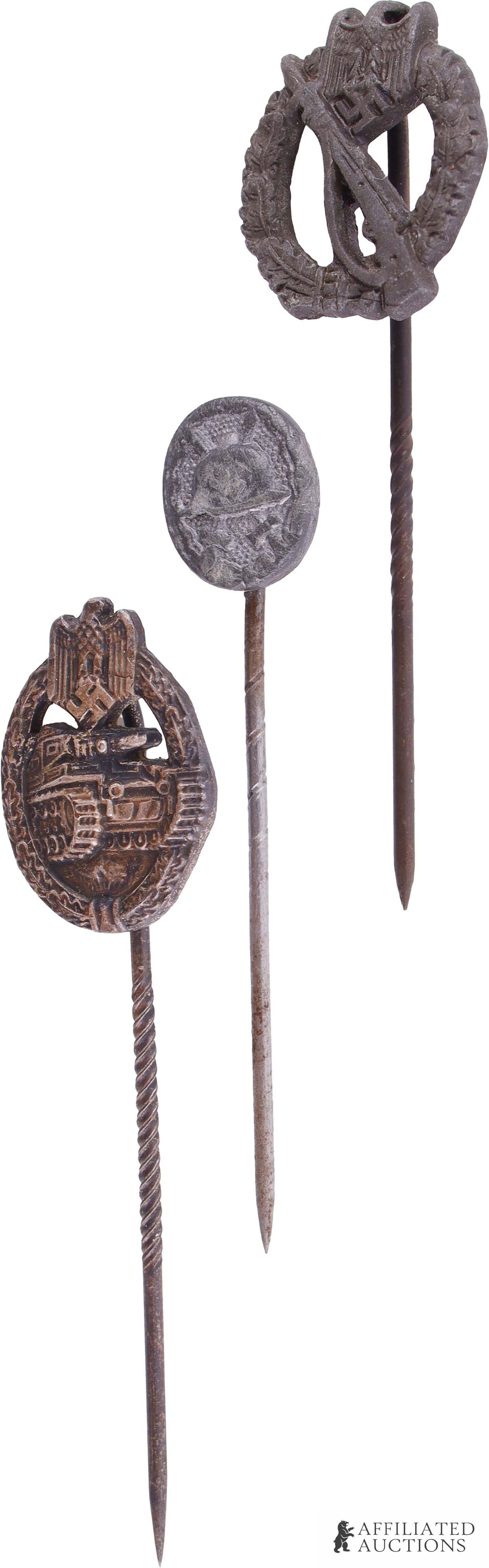 3 WWII German Veteran Stickpins: Lot contains three (3) stickpins depicting an Infantry Assault badge, Panzer Assault badge, and Black Wound badge. 1.5cm x 1.25cm.