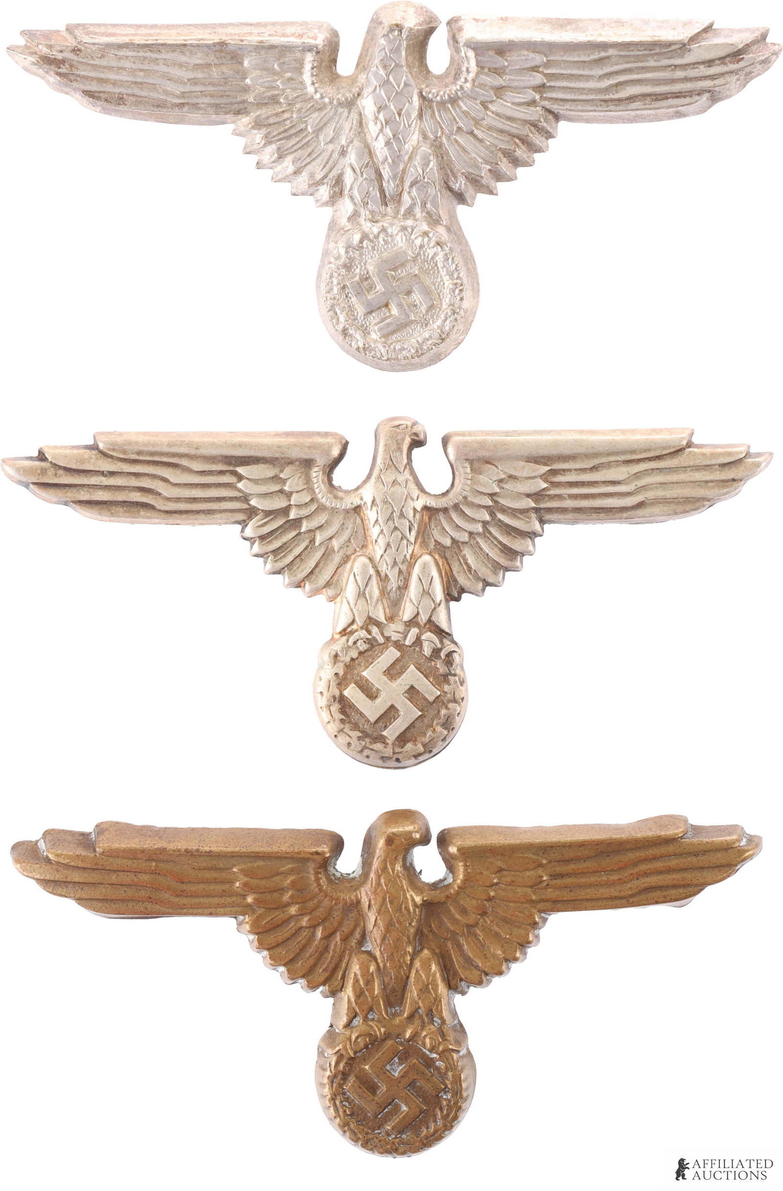 Lot of 3 WWII German SS Visor Cap Eagles: Lot features one bronze eagle marked RZM, one nickel eagle marked RZM and has short pins, and another nickel silver eagle marked RZM. Each with different heads. Measure 68mm.
