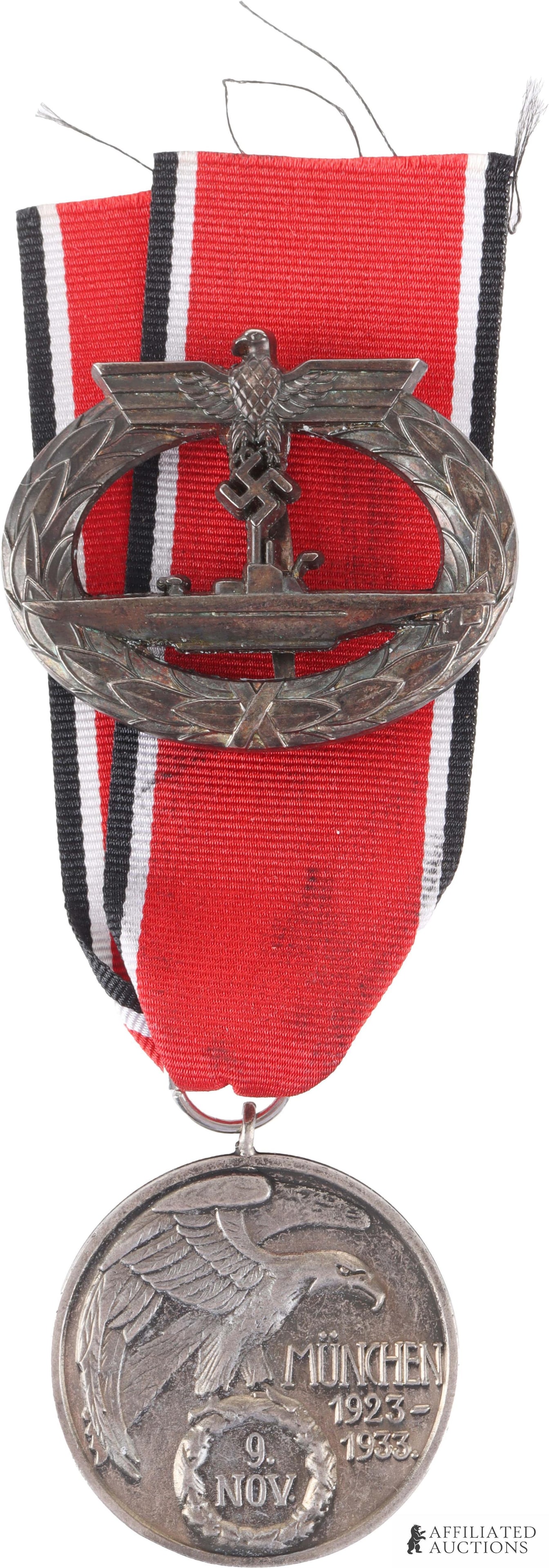 U-Boat Badge & Blood Order Medal WWII German Reich: A two-item lot containing the following items: 1) a U-boat badge marked on reverse 'Schwerin Berlin 68' weighing 20 grams, and 2) a 1923-1933 9. Nov. German Blood Order medal, marked on reverse '1408'