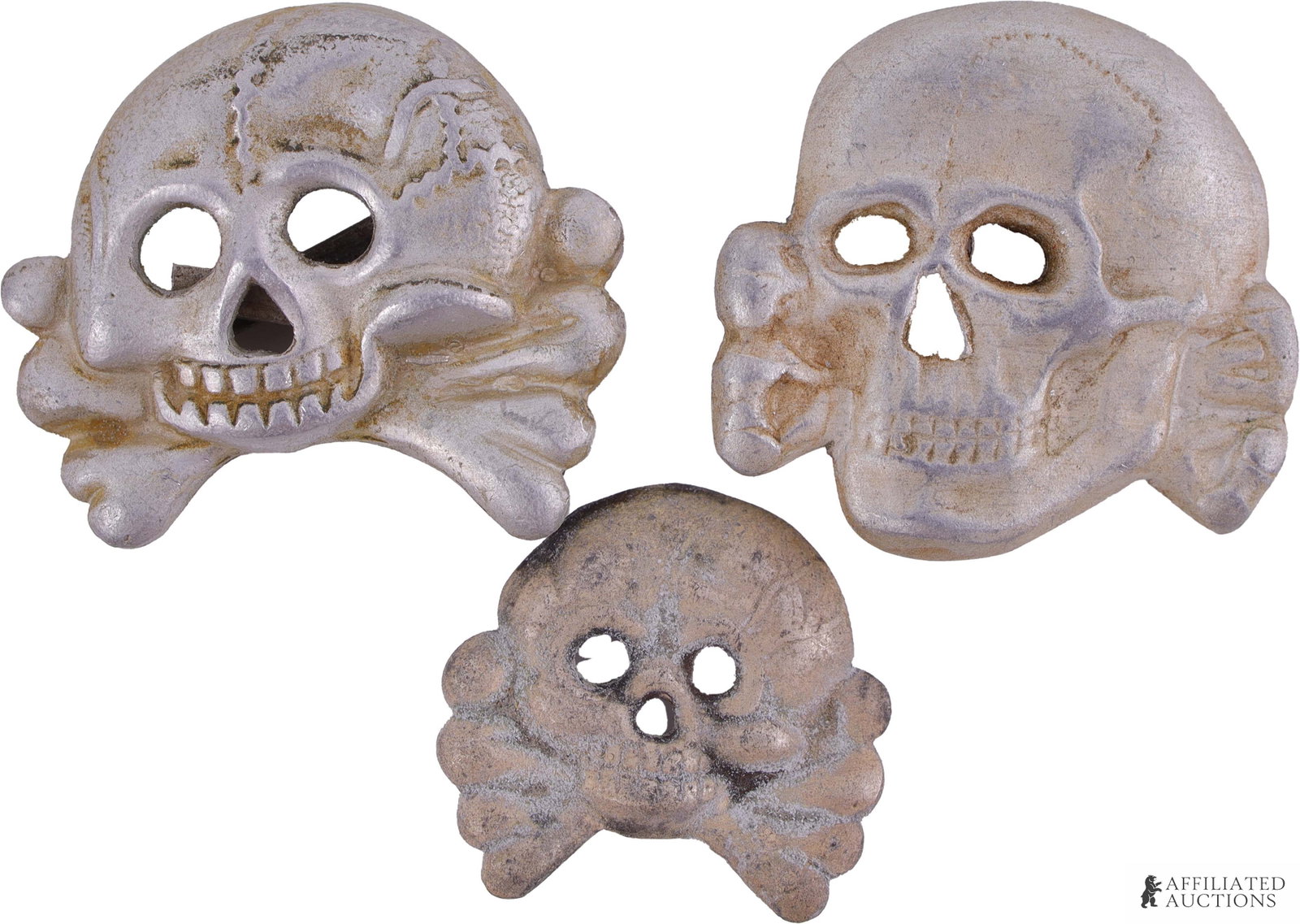WWII Totenkopf Insignia Pins Lot of 3 German Reich: A lot of three WWII German Totenkopf insignia pins; two of them measure approximately 1 1/4 inch by 1 1/4 inch, while the third measures approx. 1 inch by 1 inch. One Totenkopf is stamped on the rever