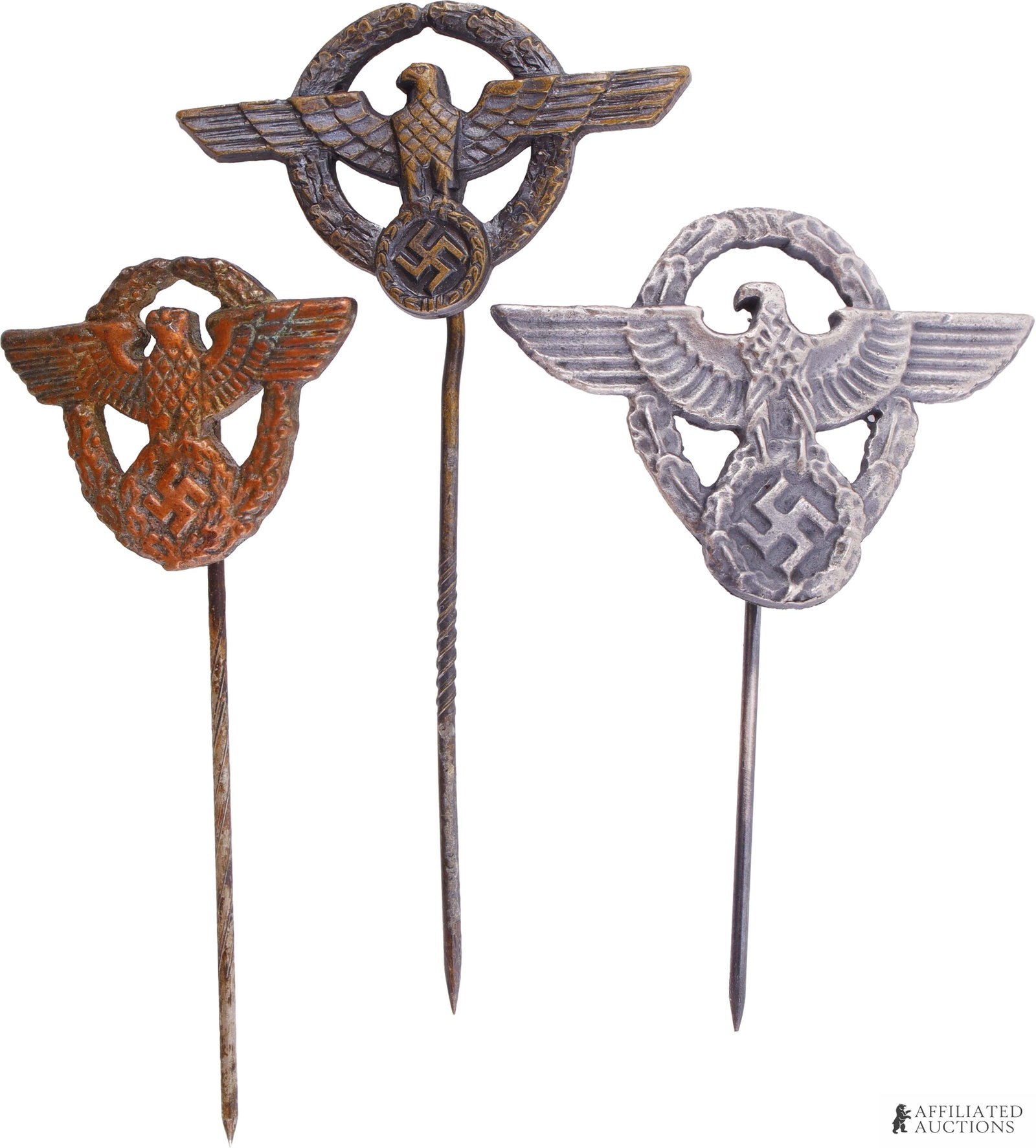 Three WWII German Civilian Support Stickpins: Lot contains three (3) stickpins depicting the national eagle surrounded by a wreath. Measure 3cm x 2.5cm.