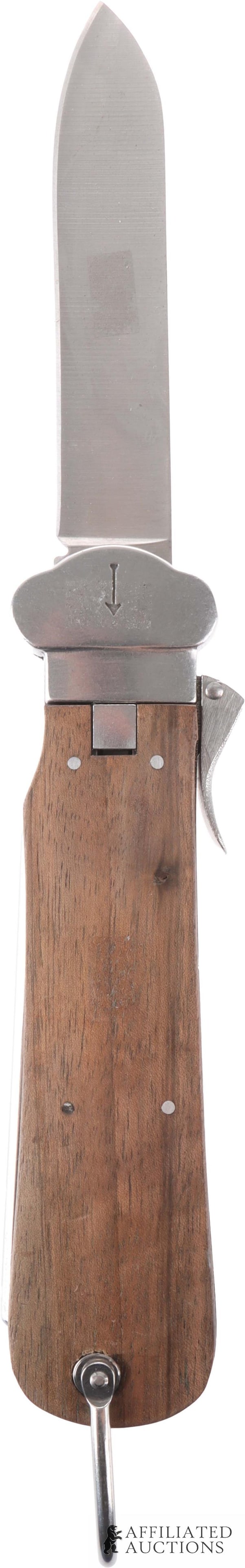 Fallschirmjager Messer Knife WWII German: A fallschirmjaeger gravity knife (Flieger-Kappmesser). Wood grips, incised arrow mark, and spike for disentangling parachute lines. This knife was produced by At the Front, and has their usual high qu