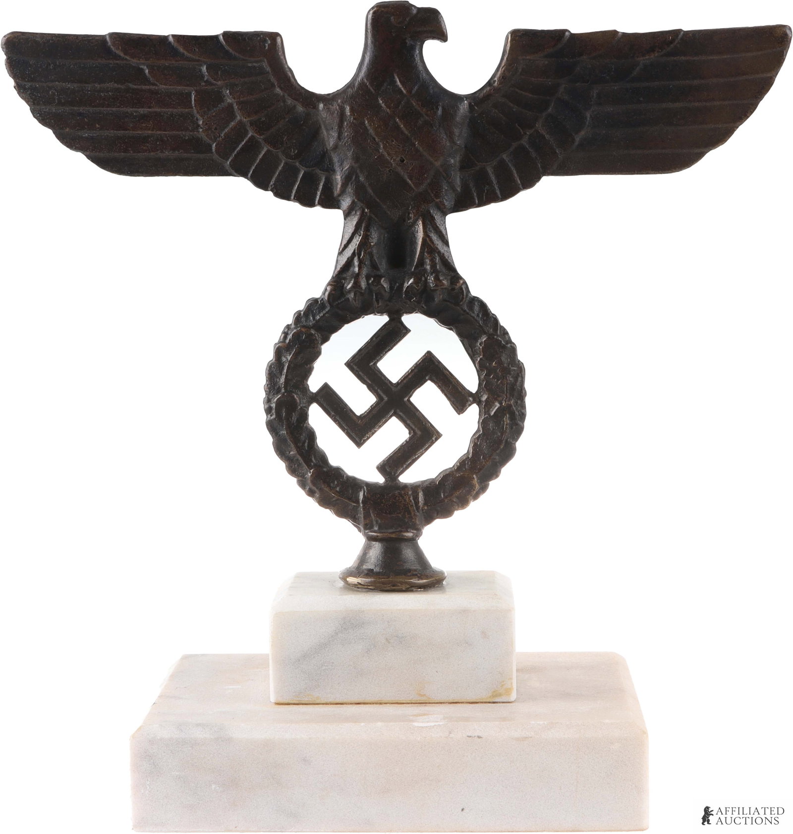 WWII German Desk Eagle Parteiadler Ornament: A Parteiadler eagle ornament constructed of brass or bronze, on a base made of white marble or similar. Measures approximately 6 1/8 inches by 4 1/8 inches by 9 3/4 inches.
