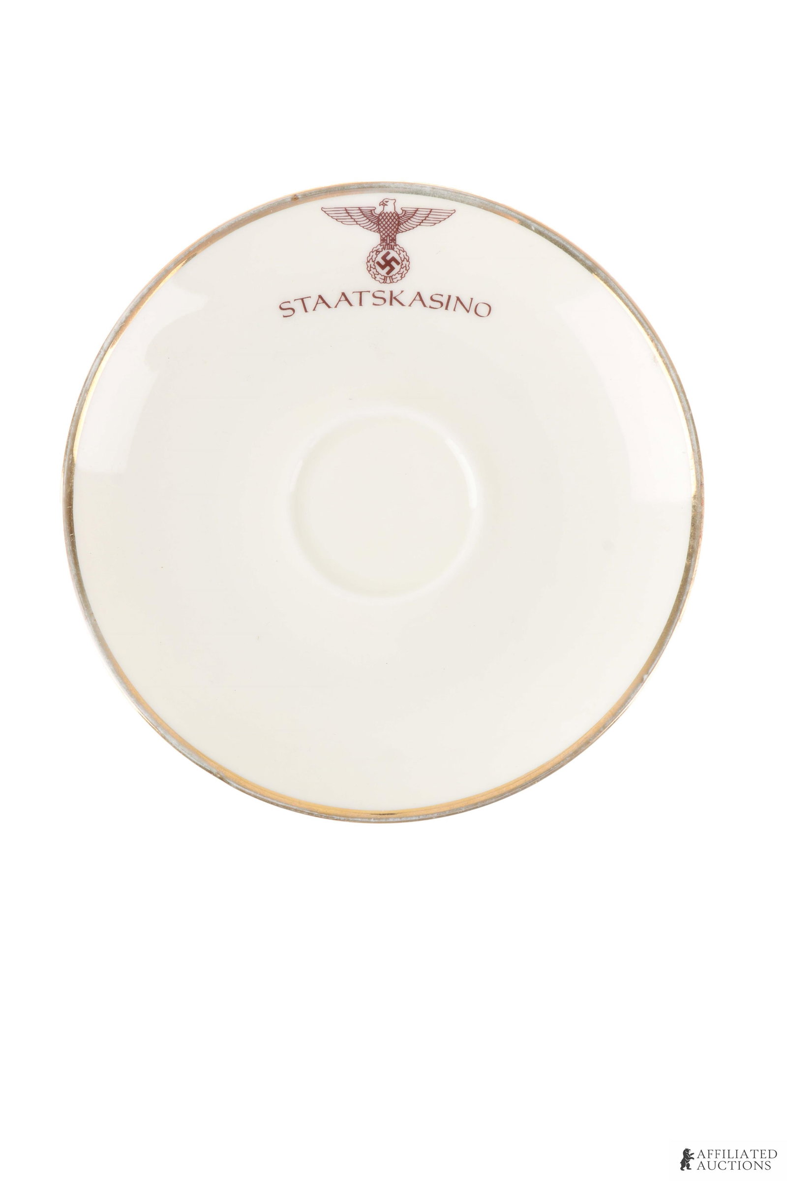 Staatskasino Porcelain Saucer German Third Reich: A 6-inch Staatskasino Krakau teacup saucer with a gold-colored rim. Stamped on the underside with maker's mark 'Eschenbach Bavaria - Germany' under a crown, as well as production number W2079.
