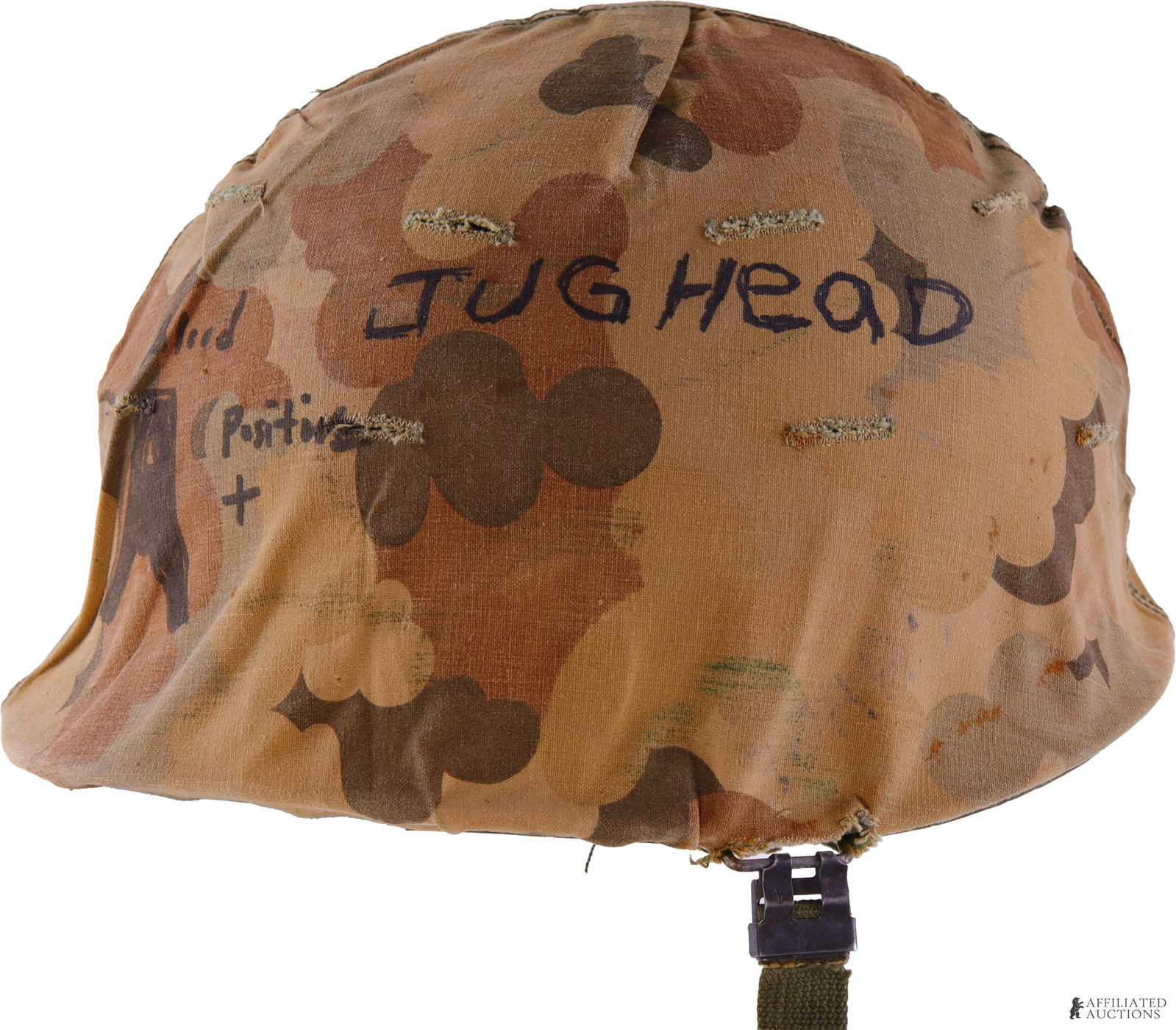 U.S. M1 Helmet with Inscribed Mitchell Camouflage: A U.S. M1 steel helmet with separate liner, fabric chinstrap, and Mitchell-pattern camouflage cover displayed with the brown camouflage side outward. Cover bears handwritten inscriptions including "JU