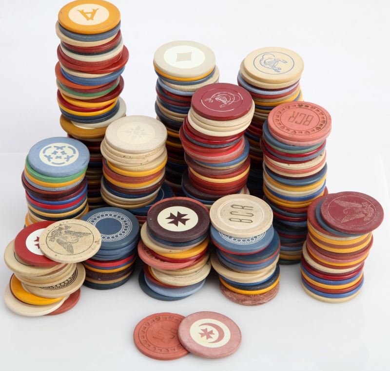 OVER 4 POUNDS OF VINTAGE CLAY POKER CHIPS: Over four pounds of vintage clay poker chips. Various design and markings. Very good condition.