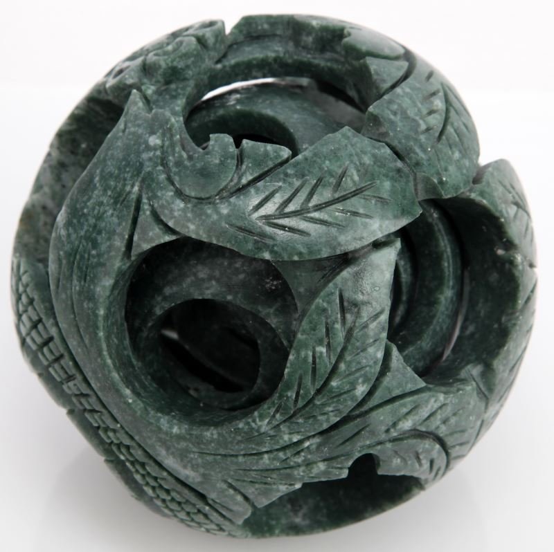 FINE CARVED JADE 5 LAYER PUZZLE BALL: Fine hand-carved Jade 5 layer puzzle ball. Floral and leaf motif. Measures 15 inches circumference. Very good condition.