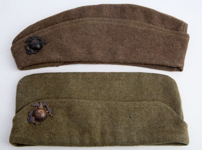 USMC WWI GARRISON CAP LOT OF TWO LAT LON EGA'S: One of the hats is a 1913 British made size 7 1/2 with screw back EGA and 14 on verso, free of mothing in very good condition, the second is unmarked has a small moth hole has same as other hat EGA wi