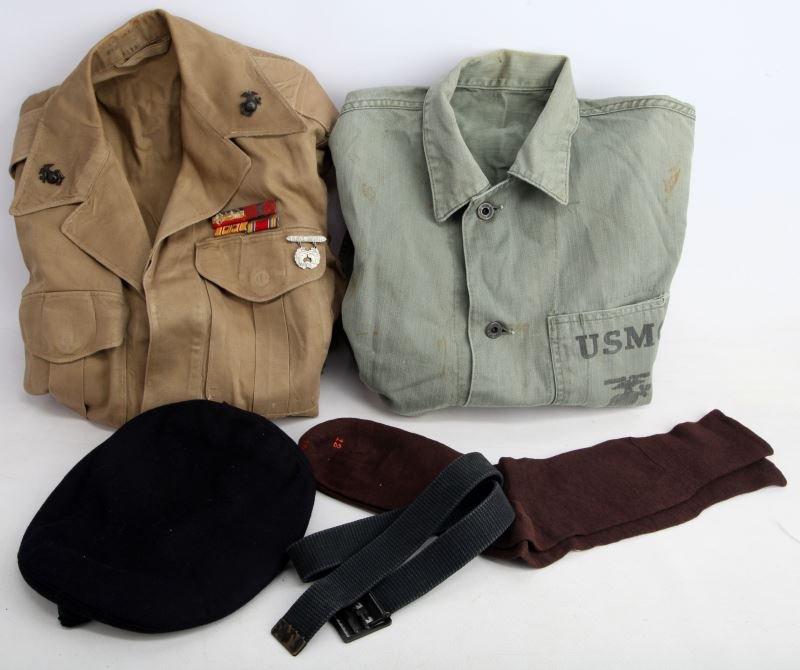 MIXED GROUPING OF WWII US CLOTHING ITEMS: Mixed grouping of US Military items including a kakahi WWII Marine Ike jacket with EGA's, ribbons, pistol expert badge and sgt chevron; WWII USMC HBT shirt with hole in left sleeve; USMC WWII brown so