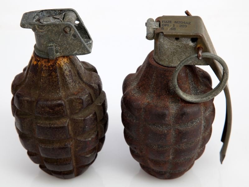 TWO WWII INERT PINEAPPLE FRAGMENT GRENADE: Two U.S. WWII "pineapple" grenades both are inert show some signs of oxidation. Both are in good to very good condition. One is marked "Fuze M204A2 OPI-1-209 5-68".