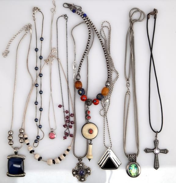 SMALL LOT LADIES STERLING FASHION NECKLACES: Ten necklaces in all, varied lengths and stones, such as amethyst, red coral, bone. glass beading, black onyx, etc.. Contemporary and antique type designs.