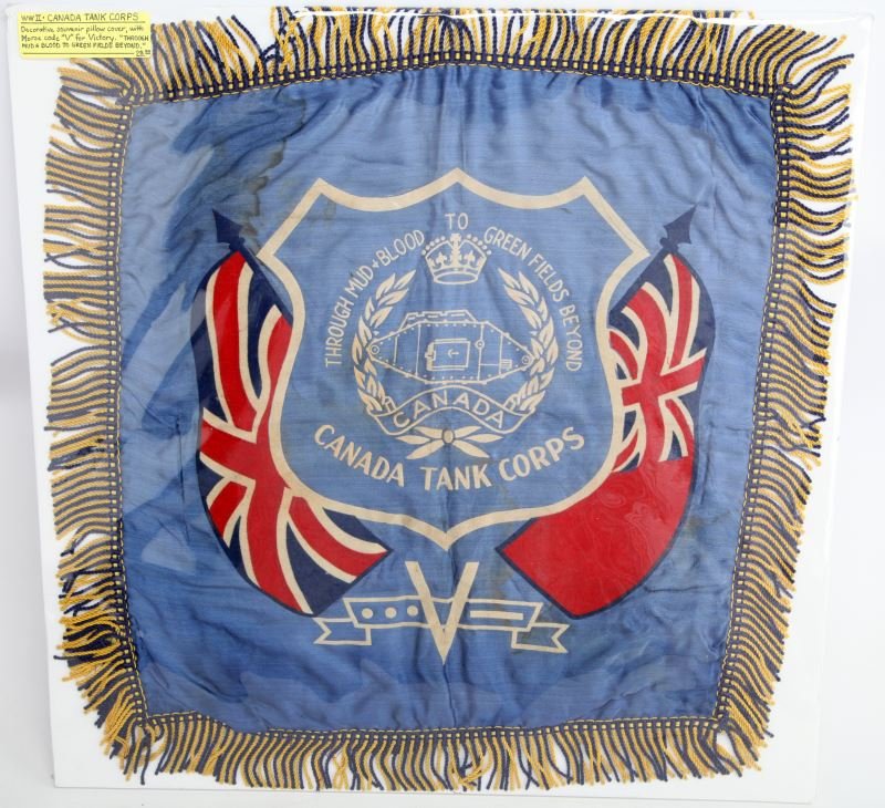 WWII CANADA TANK CORPS PILLOW COVER: WWII Canada Tank Corps decorative souvenir pillow cover with morse code "V" for victory. Through Mud & Blood To Green Fields Beyond. Measures at 17.5 inches by 17.5 inches. In good condition with some