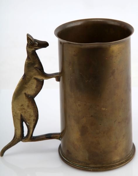 BRASS TRENCH ART STEIN WITH KANGAROO HANDLE: Stein is made from a brass shell, with many markings (Broad arrow marks, inscription "From Lavenson's Radioi 226 Pitt st Sydney", G15, & No 1II SH&S 1/41). Handle is in shape of a kangaroo made from b