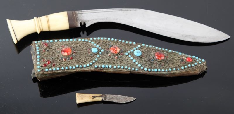INDIA ANTIQUE GURKHA KNIFE WITH ORIGINAL SCABBARD: Antique India Gurkha knife with bone handle and original scabbard encrusted in turquoise and red stones. Blade is free of pitting, rusting and dents. Includes mini knife. Measures 13 inches in length.