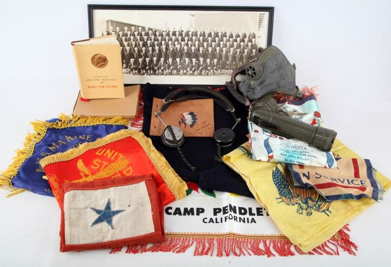 WWII TO COLD WAR MILITARY & HOMEFRONT COLLECTIBLES: Box of a variety of military related items to include two Son in Service flags, four USMC pillow covers and one Great Lakes Training US Navy, US Army Fulton flashlight, Army Air Corp flight head set b