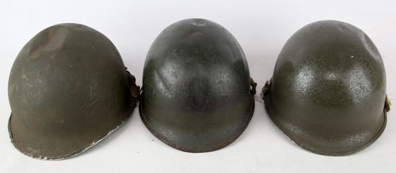 3 WWII M-1 SWIVEL BALE HELMETS WITH CHIN STRAPS: Sadly each helmet is dented, center seam with earl sewn chin straps.