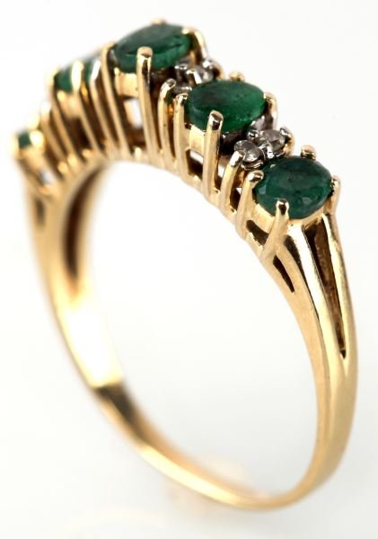 LADIES 10K YELLOW GOLD EMERALD AND DIAMOND RING: Higher profile gallery type design, containing five oval shape emeralds, each 4mm x 3mm, plus eight round full cut diamonds, .015ct. each, set between emeralds. Size: 7 Weight: 2.4 g Condition: very g