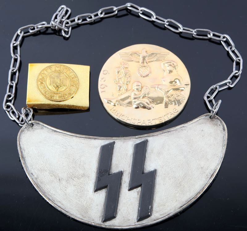 THREE REPRODUCTION WWII GERMAN MILITARY ITEMS: This group of reproduction items include one gold painted Gott Mit Uns belt buckle, one SS gorget, and one large brass coin marked "1939 Reichsparteitag" on the front and "N.S. KAMPFSPIELE 1939 DEM SI