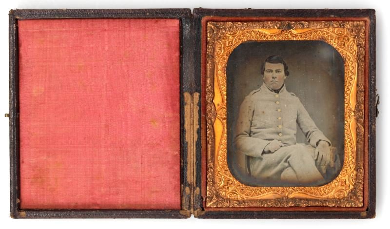 CIVIL WAR AMBRO UNIDENTIFIED CSA SOLDIER FLORIDA: Sixth plate early clear glass Ambrotype of an unidentified Civil War Confederate soldier, possibly Florida infantry. He is seated and the uniform is very plain with no trim, with a short grey 9 button