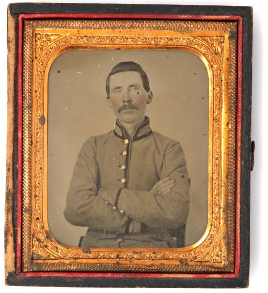 CIVIL WAR AMBROTYPE UNNAMED CONFEDERATE SOLDIER: Sixth-plate ambrotype of unnamed Civil War Confederate soldier. Dressed in butternut trousers and coat. Black cord trims the collar, cuffs and down the front of the jacket. Appears to have a small poc
