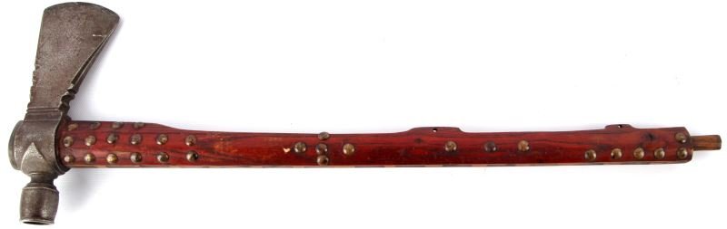 PLAINS INDIAN PIPE TOMAHAWK: Late-19th / early-20th Century plains Indian pipe tomahawk (possibly Wild West Show). 18 inch wood handle, decorated with brass tacks, with iron axe head secured by a pewter ring at top. Overall very 
